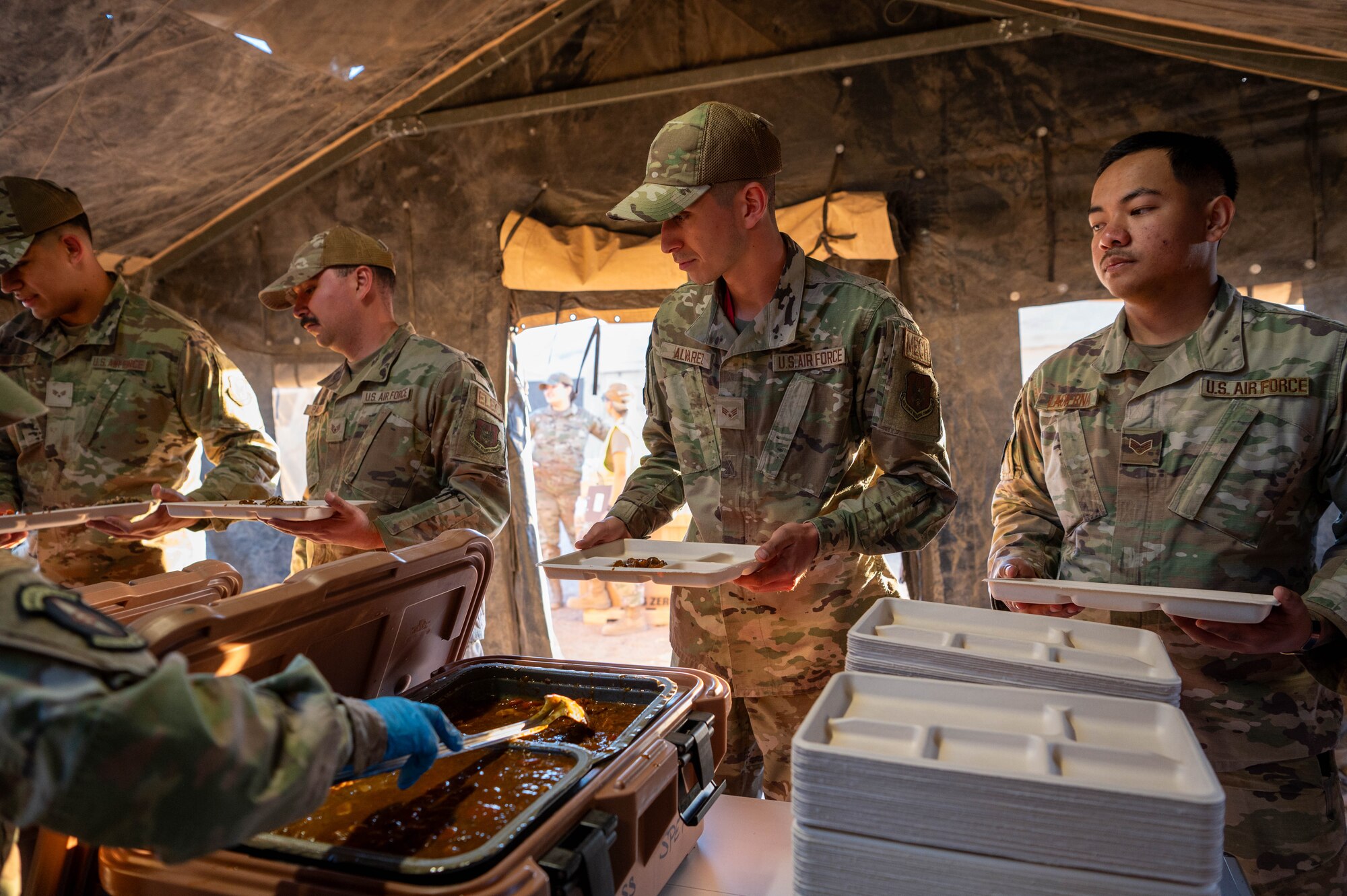 944th Fighter Wing Reserve Citizen Airmen line up to receive meals during Exercise Desert Hammer 25-1 at Gila Bend Air Force Auxiliary Field near Gila Bend, Ariz., Nov. 14, 2024. Exercise Desert Hammer 25-1 emphasizes the U.S. Air Force Reserve’s commitment to readiness by integrating Agile Combat Support and Large Force Exercise capabilities in a contested environment. (U.S. Air Force photo by Senior Airman Alexis Orozco)