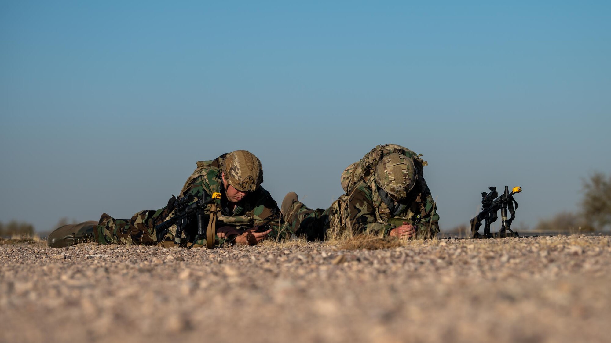 Two 944th Fighter Wing U.S. Air Force Reserve Citizen Airmen dawn Mission Oriented Protective Posture (MOPP) gear and practice tactical field operations during Exercise Desert Hammer 25-1 at Auxiliary Field 6 near Gila Bend, Ariz., Nov. 15, 2024. This large-scale exercise showcases the adaptability of Mission Ready Airmen, advancing the skills needed to thrive in the rapidly evolving challenges of global competition. (U.S. Air Force photo by Senior Airman Jacob Dastas)