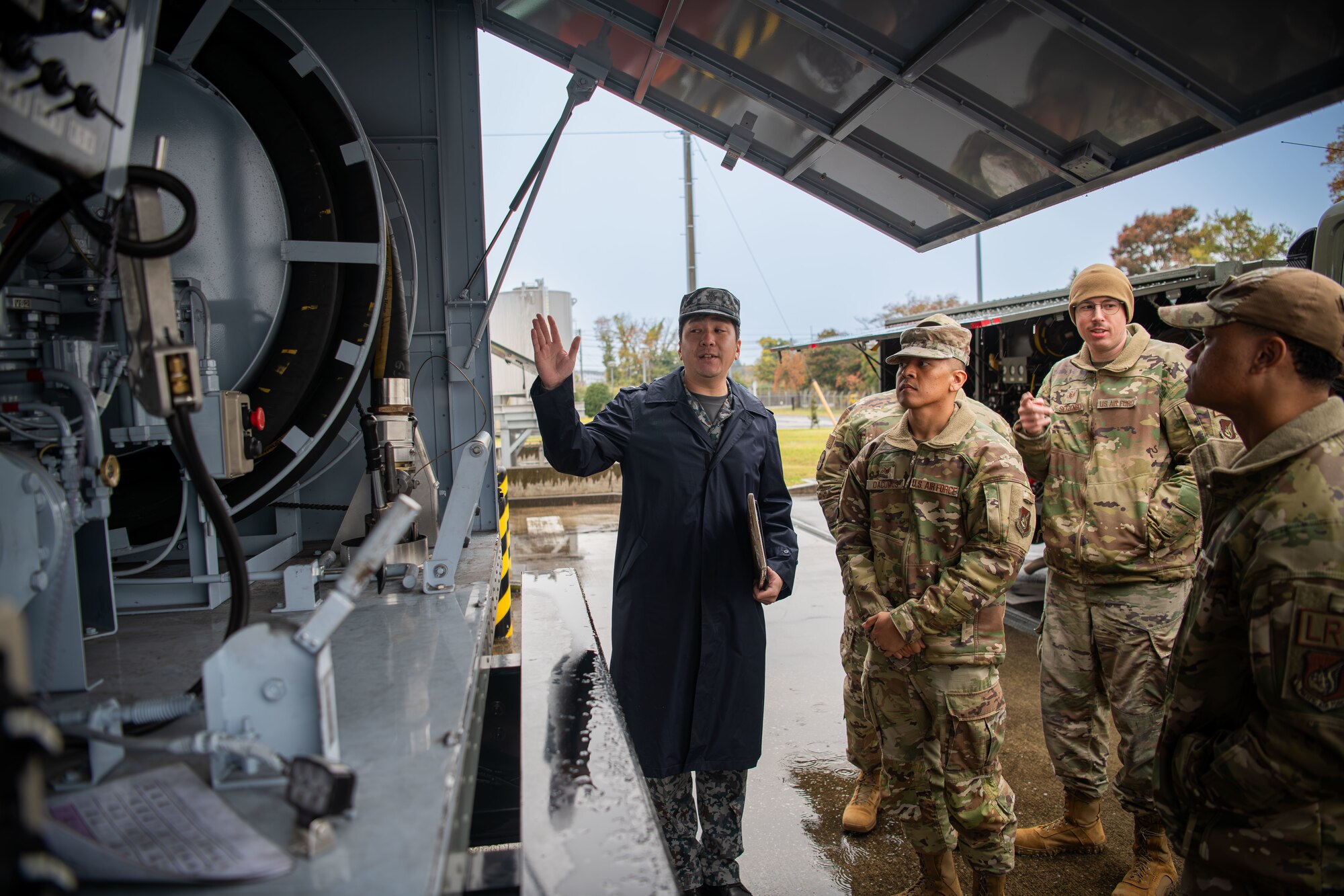 JASDF member guides a tour of personnel from the 374th Logistics Readiness Squadron.