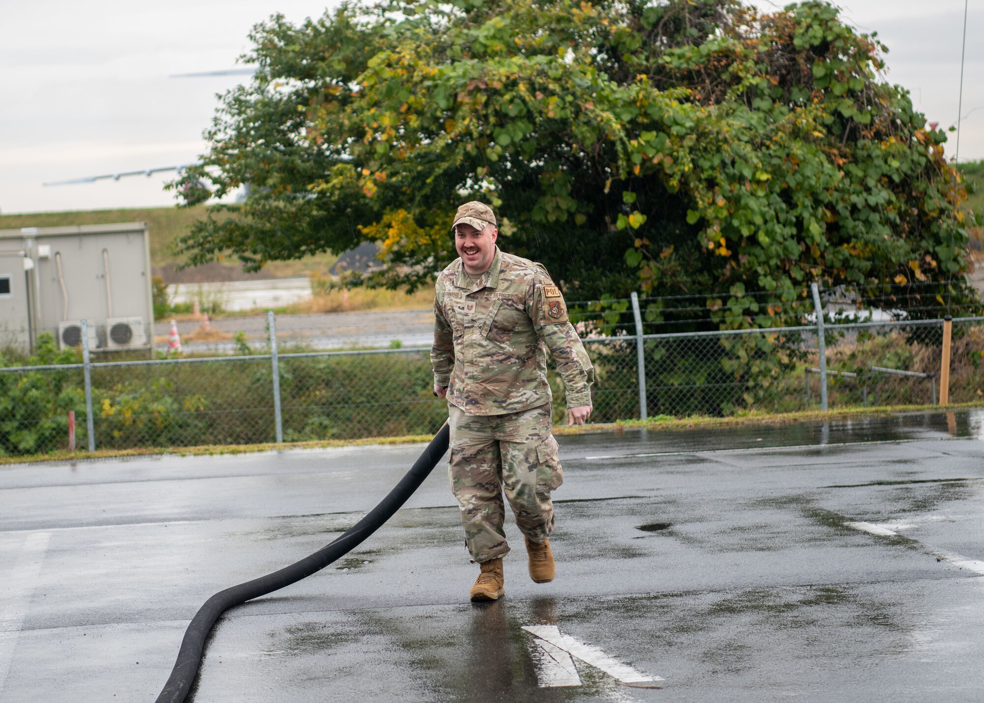 Airman participates in a fuel hose carry.