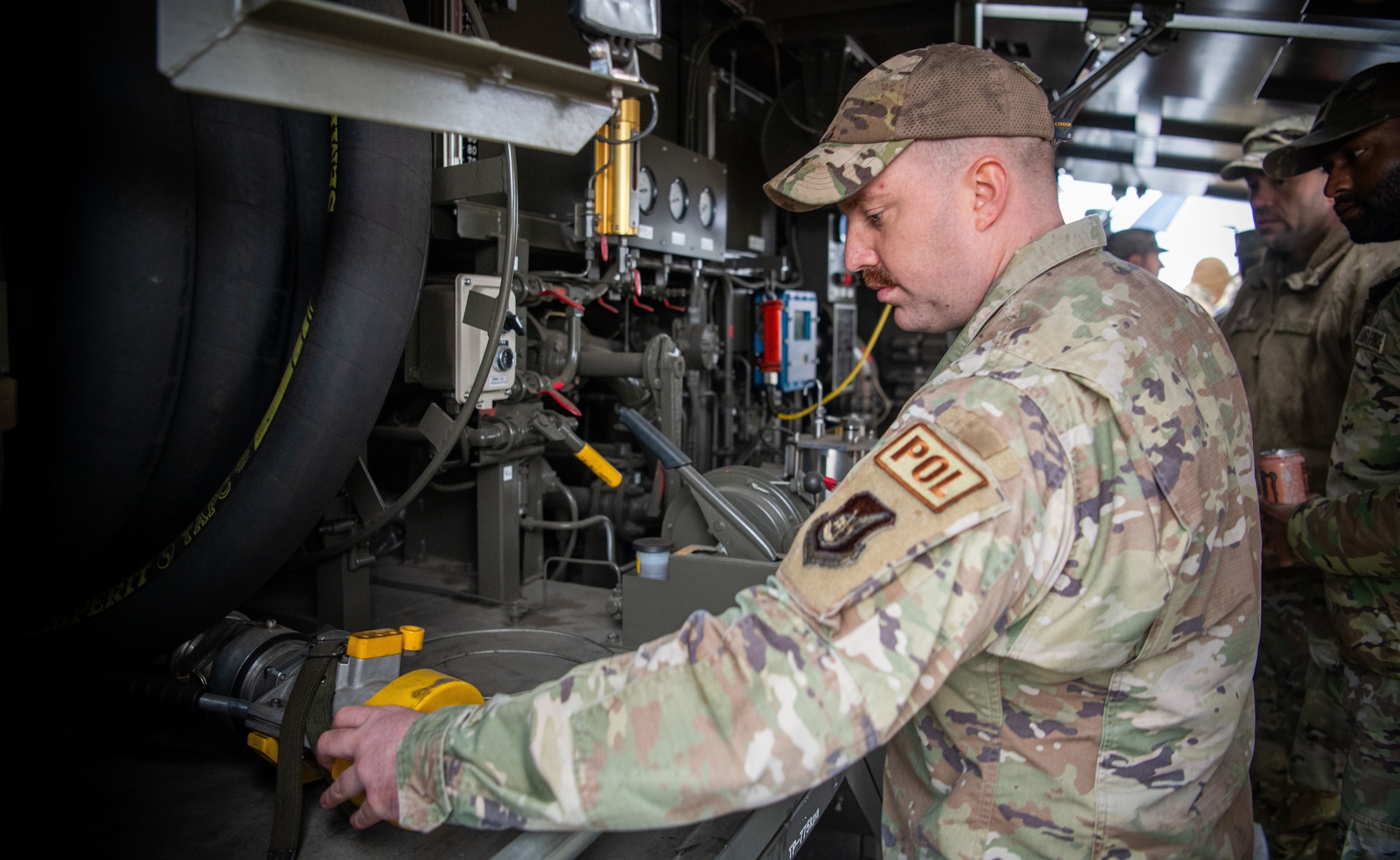 Airman takes a closer look at a fuel hose.