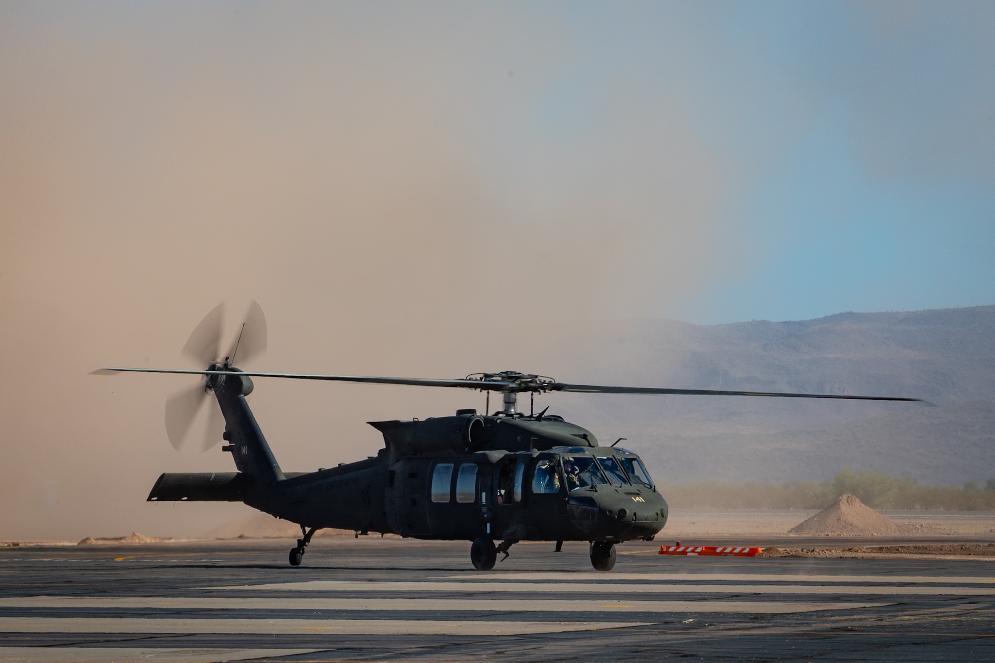 An Arizona Army National Guard UH-60 Black Hawk stirs up dust while landing during Exercise Desert Hammer 25-1 at Gila Bend Air Force Auxiliary Field near Gila Bend, Ariz., Nov. 14, 2024. Exercise Desert Hammer 25-1 emphasizes the U.S. Air Force Reserve’s commitment to readiness by integrating Agile Combat Support and Large Force Exercise capabilities in a contested environment. (U.S. Air Force photo by Tech. Sgt. Tyler J. Bolken)