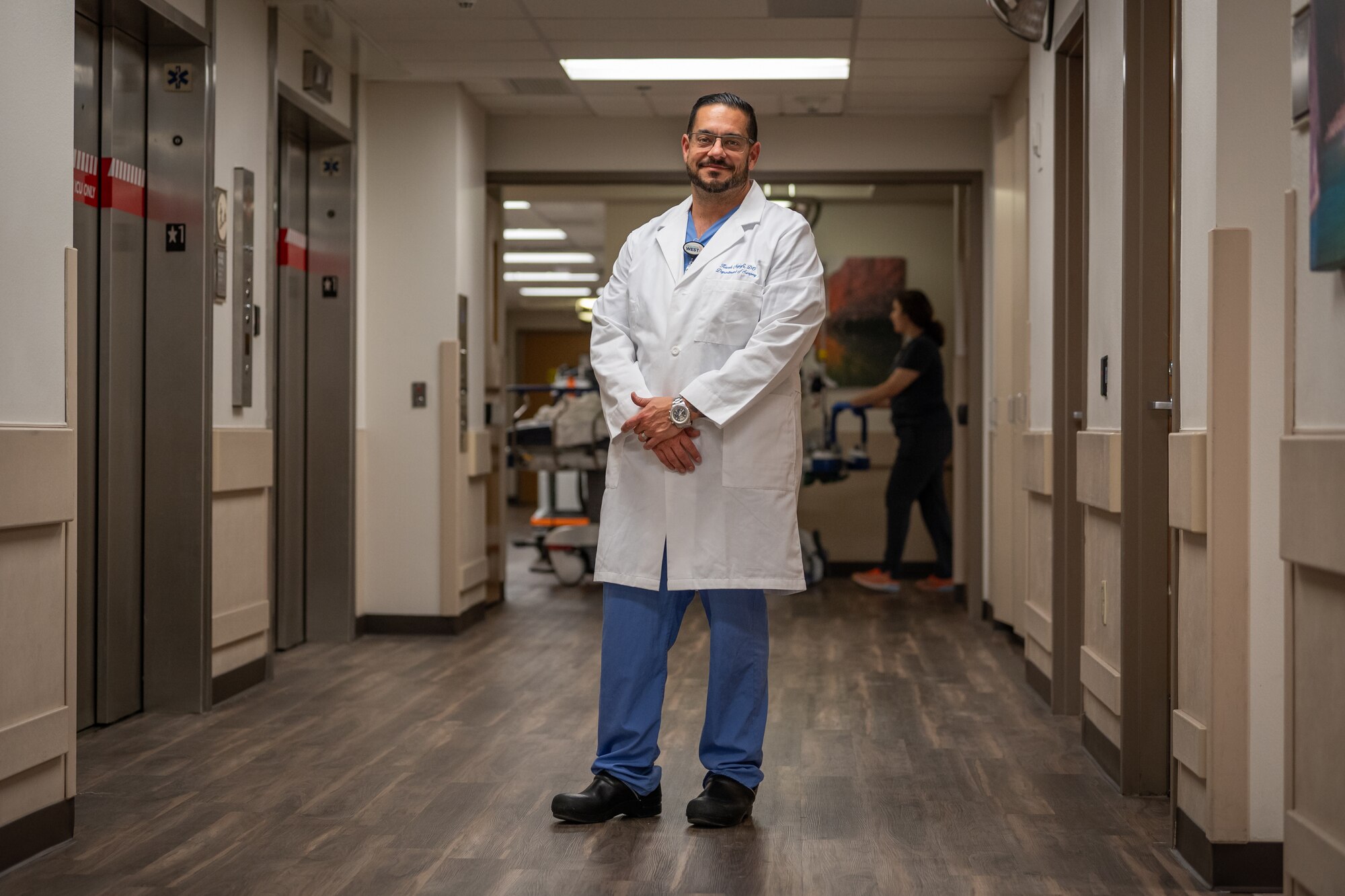 Dr. Kaveh Najafi, Trauma Medical Director at HonorHealth Scottsdale Osborn Medical Center, stands in a hospital hallway in Scottsdale, Ariz., Nov. 14, 2024. Civilian medical personnel from HonorHealth participated in Exercise Desert Hammer 25-1, receiving simulated patients from military personnel, bridging gaps in terminology and protocols. Najafi highlighted that many trauma care advancements, such as damage control operations and blood resuscitation techniques, originate from military medicine. (U.S. Air Force photo by Tech. Sgt. Tyler J. Bolken)
