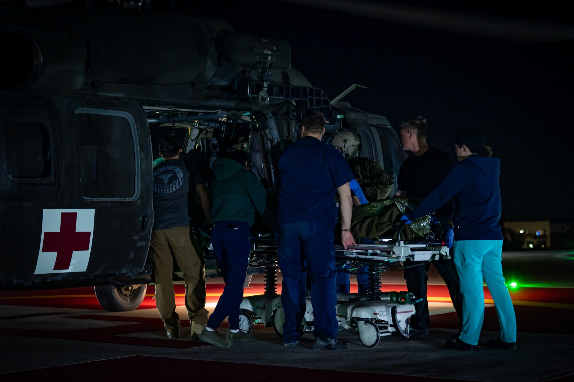 Civilian medical personnel and service members from the 944th Fighter Wing and Arizona Army National Guard work together to unload a simulated patient from a UH-60 Black Hawk helicopter during Exercise Desert Hammer 25-1 at HonorHealth Scottsdale Osborn Medical Center in Scottsdale, Ariz., Nov. 14, 2024. This large-scale exercise showcases the adaptability of Mission Ready Airmen, advancing the skills needed to thrive in the rapidly evolving challenges of global competition. (U.S. Air Force photo by Tech. Sgt. Tyler J. Bolken)