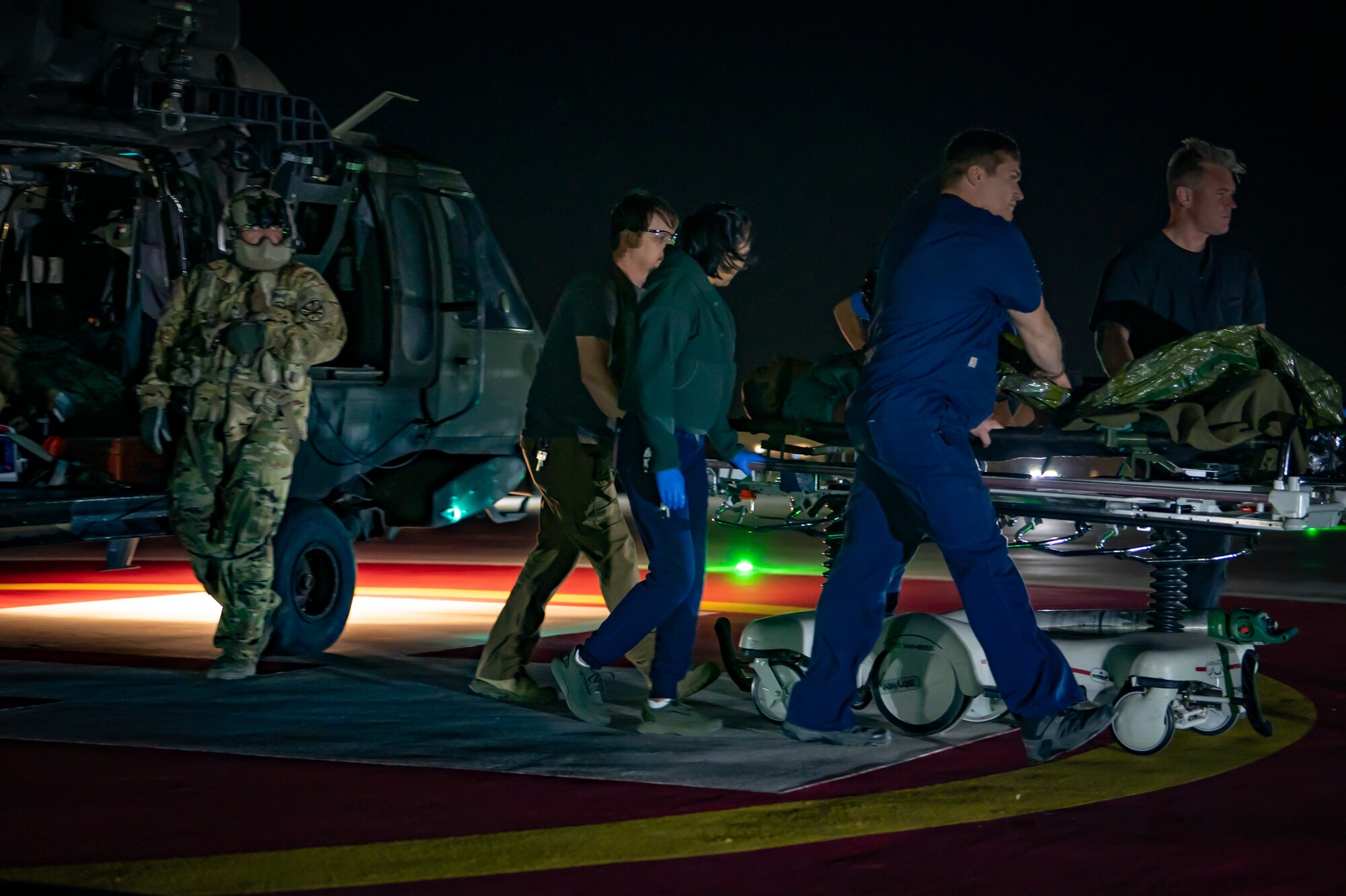 Medical staff move a simulated patient to the emergency department after an Arizona Army National Guard UH-60 Black Hawk MedEvac landing at HonorHealth Scottsdale Osborn Medical Center in Scottsdale, Ariz., Nov. 14, 2024. Civilian medical personnel from HonorHealth participated in Exercise Desert Hammer 25-1, receiving simulated patients from military personnel, bridging gaps in terminology and protocols. (U.S. Air Force photo by Tech. Sgt. Tyler J. Bolken)