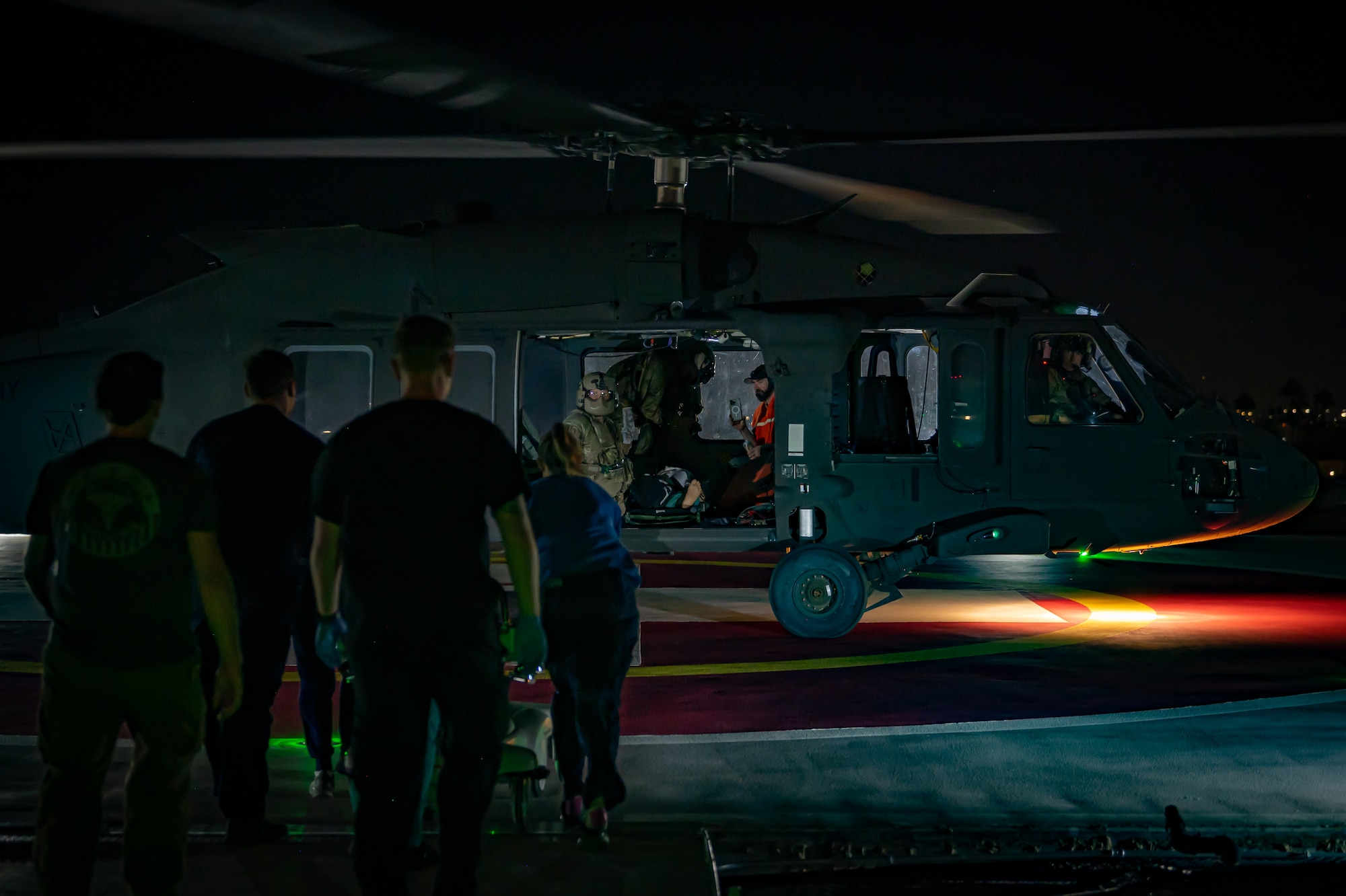 Civilian medical personnel and service members from the 944th Fighter Wing and Arizona Army National Guard work together to receive a simulated patient during a nighttime MedEvac operation as part of Exercise Desert Hammer 25-1 at HonorHealth Scottsdale Osborn Medical Center in Scottsdale, Ariz., Nov. 14, 2024. Through joint and multinational collaboration, Desert Hammer bridges gaps in terminology and protocols between military and civilian medical teams. (U.S. Air Force photo by Tech. Sgt. Tyler J. Bolken)