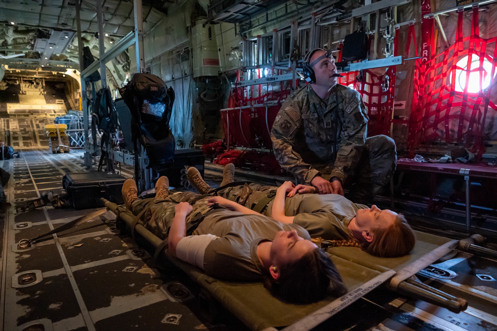 Arizona Army National Guard Capt. Jason Sellers, a Critical Care Air Transport Team (CCATT) nurse, administers medical care to simulated patients aboard a C-130 over southern Arizona after departing Davis-Monthan Air Force Base, Ariz., Nov. 15, 2024. Through joint and multinational collaboration, the 944th Fighter Wing hosts Desert Hammer to test the ability of over 700 participants and 131 aircraft to operate, defend, and sustain airbases under austere conditions across southern Arizona. (U.S. Air Force photo by Senior Airman Alexis Orozco)