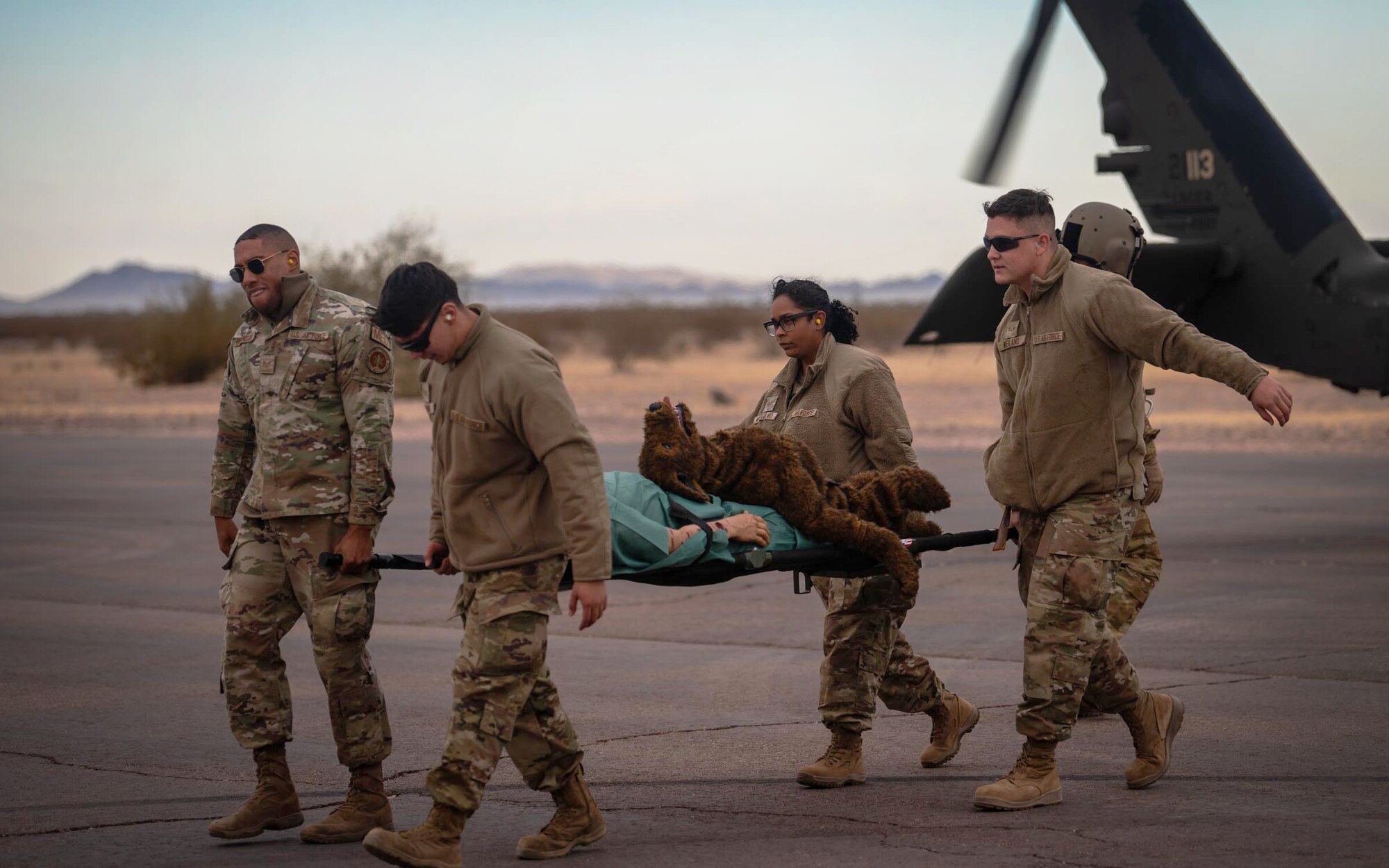 944th Fighter Wing Reserve Citizen Airmen transport a simulated casualty from an Arizona Army National Guard UH-60 Black Hawk Helicopter during Exercise Desert Hammer 25-1 at Auxiliary Field 6 near Gila Bend, Ariz., Nov. 16, 2024. Exercise Desert Hammer 25-1 emphasizes the U.S. Air Force Reserve’s commitment to readiness by integrating Agile Combat Support and Large Force Exercise capabilities in a contested environment. (U.S. Air Force photo by Senior Airman Jacob Dastas)