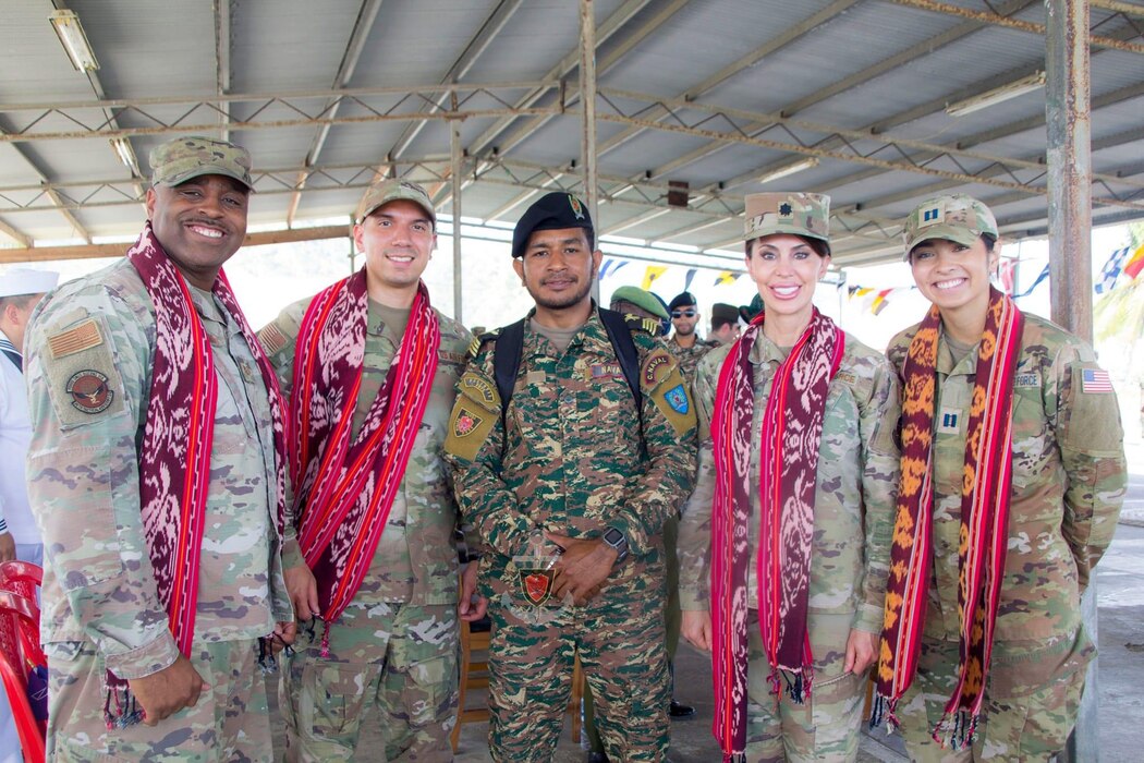 Language Enabled Airman Program Scholars Lt. Col. Meridee Trimble (USAF) and Capt. Tia Scoggan (USSF) participated in a mission in Timor-Leste and attended a ceremony on the last day of a class they provided Indonesian language support. Pictured from left to right are two USAF Air Advisors, a Timorese student recognized as a top performer, Trimble, and Scoggan