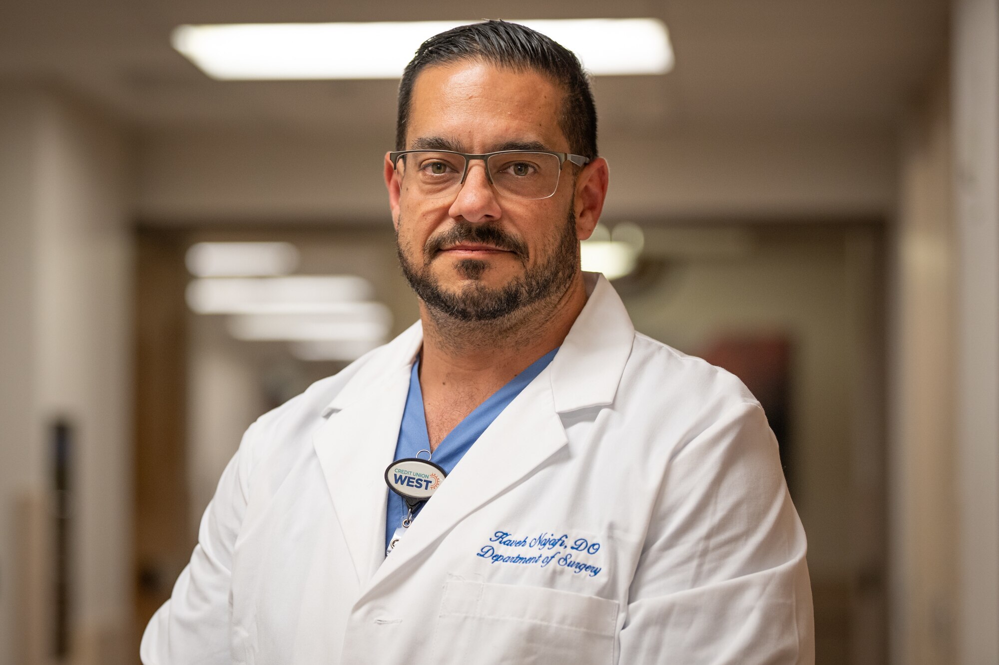 Dr. Kaveh Najafi, Trauma Medical Director at HonorHealth Scottsdale Osborn Medical Center, stands in a hospital hallway in Scottsdale, Ariz., Nov. 14, 2024. Civilian medical personnel from HonorHealth participated in Exercise Desert Hammer 25-1, receiving simulated patients from military personnel, bridging gaps in terminology and protocols. Najafi highlighted that many trauma care advancements, such as damage control operations and blood resuscitation techniques, originate from military medicine. (U.S. Air Force photo by Tech. Sgt. Tyler J. Bolken)