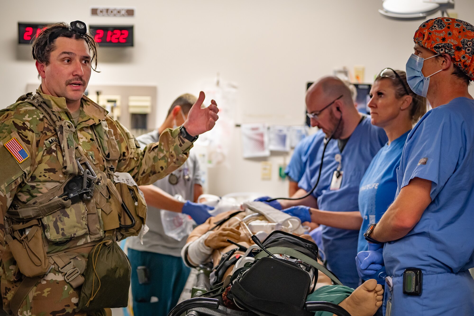 An Arizona Army National Guard UH-60 Black Hawk helicopter crew member gives medical updates to civilian medical personnel during the transport of a simulated patient at HonorHealth Scottsdale Osborn Medical Center in Scottsdale, Ariz., Nov. 14, 2024, during Exercise Desert Hammer 25-1. Civilian medical personnel from HonorHealth participated in Exercise Desert Hammer 25-1, receiving simulated patients from military personnel, bridging gaps in terminology and protocols. This exercise tests the ability of over 700 participants and 131 aircraft to operate, defend, and sustain airbases under austere conditions. (U.S. Air Force photo by Tech. Sgt. Tyler J. Bolken)