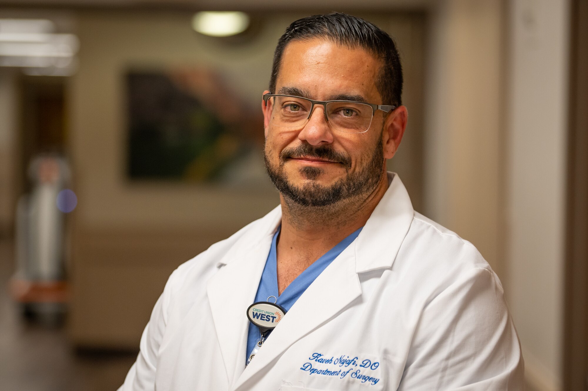 Dr. Kaveh Najafi, Trauma Medical Director at HonorHealth Scottsdale Osborn Medical Center, stands in a hospital hallway in Scottsdale, Ariz., Nov. 14, 2024. Civilian medical personnel from HonorHealth participated in Exercise Desert Hammer 25-1, receiving simulated patients from military personnel, bridging gaps in terminology and protocols. Najafi highlighted that many trauma care advancements, such as damage control operations and blood resuscitation techniques, originate from military medicine. (U.S. Air Force photo by Tech. Sgt. Tyler J. Bolken)