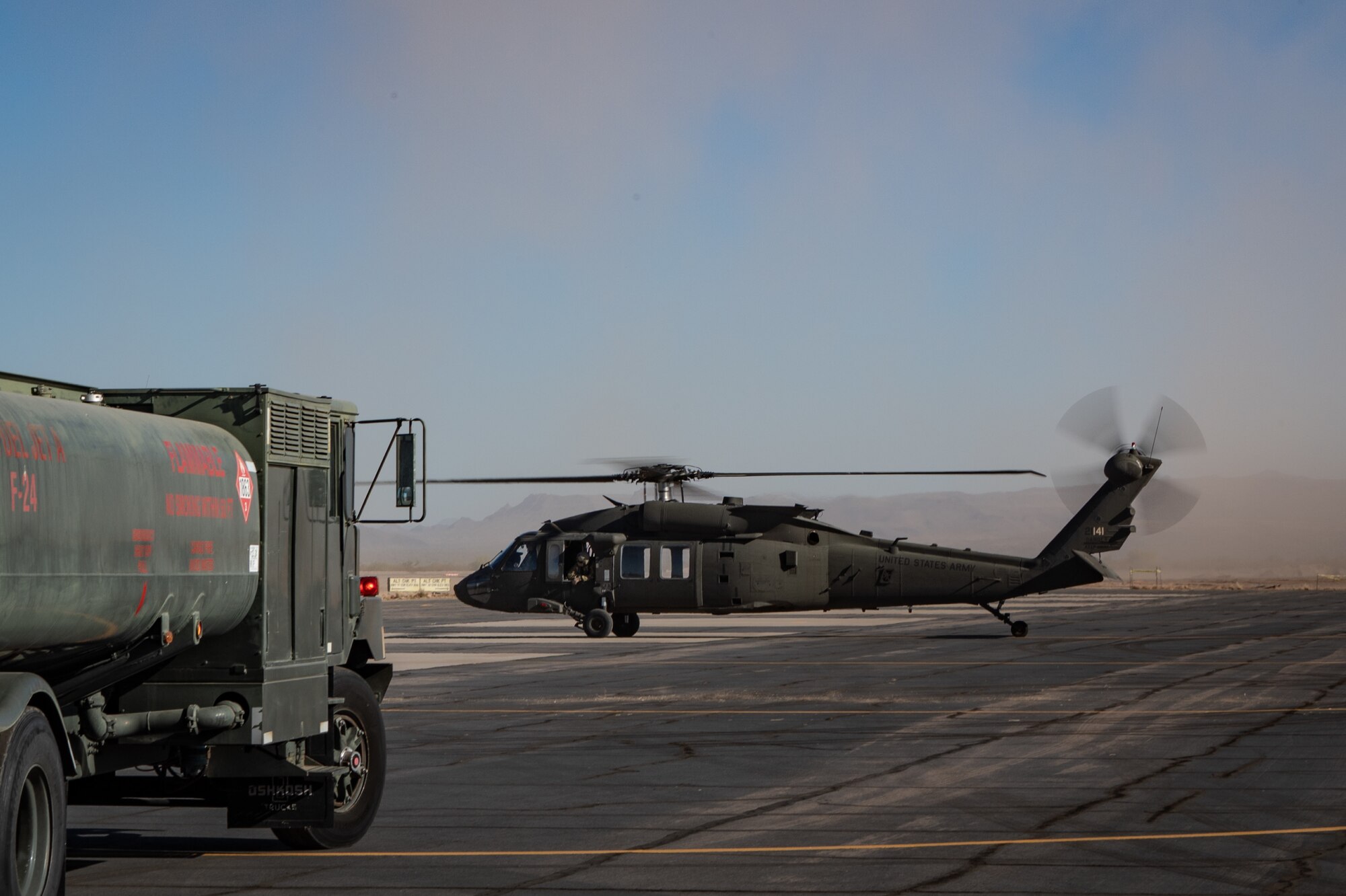 An Arizona Army National Guard UH-60 Black Hawk prepares to refuel on the flightline during Exercise Desert Hammer 25-1 at Gila Bend Air Force Auxiliary Field near Gila Bend, Ariz., Nov. 14, 2024. This large-scale exercise showcases the adaptability of Mission Ready Airmen, advancing the skills needed to thrive in the rapidly evolving challenges of global competition. (U.S. Air Force photo by Tech. Sgt. Tyler J. Bolken)