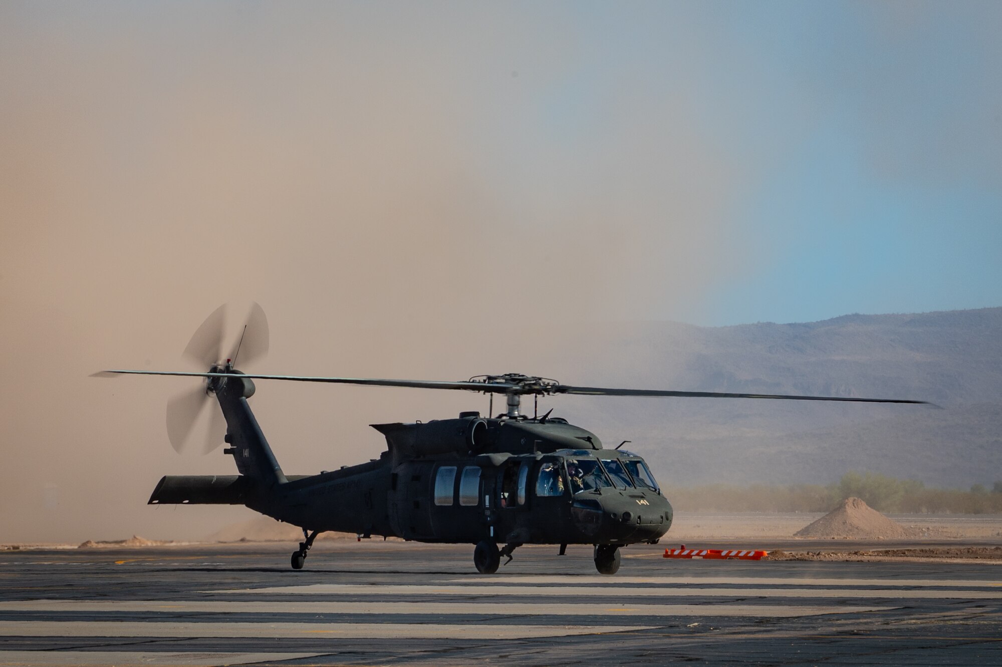 An Arizona Army National Guard UH-60 Black Hawk stirs up dust while landing during Exercise Desert Hammer 25-1 at Gila Bend Air Force Auxiliary Field near Gila Bend, Ariz., Nov. 14, 2024. Exercise Desert Hammer 25-1 emphasizes the U.S. Air Force Reserve’s commitment to readiness by integrating Agile Combat Support and Large Force Exercise capabilities in a contested environment. (U.S. Air Force photo by Tech. Sgt. Tyler J. Bolken)