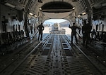 Airmen load cargo onto a C-17