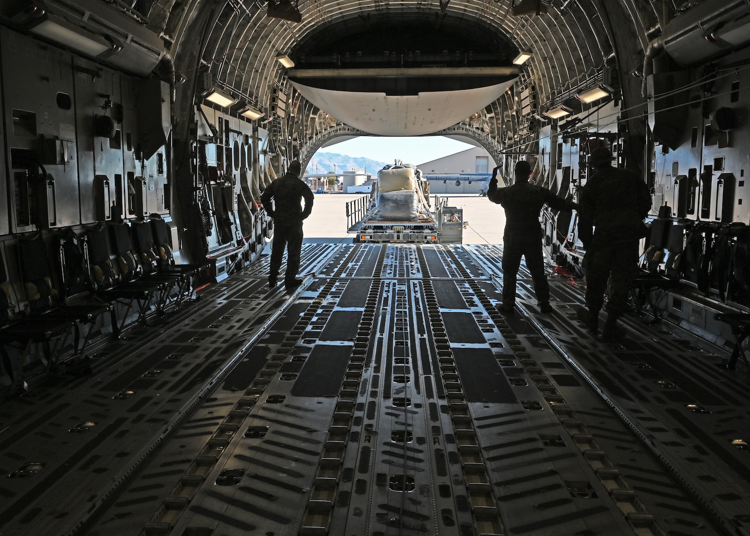 Airmen load cargo onto a C-17