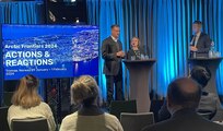 Three speakers stand on stage during Artic Frontiers 2024 conference.