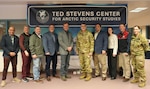 Maj. Gen. Matthew McFarlane stands with leaders at the Ted Stevens Center before visiting and touring the center.