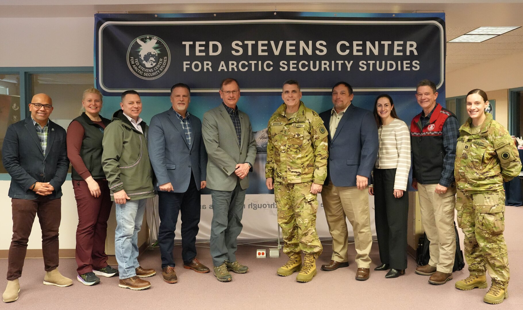 Maj. Gen. Matthew McFarlane stands with leaders at the Ted Stevens Center before visiting and touring the center.