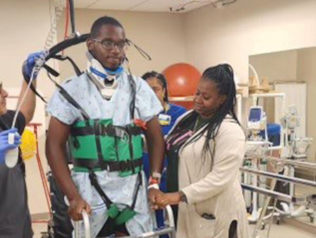 PFC Michael Romulus is learning to walk again during physical therapy.