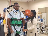 PFC Michael Romulus is learning to walk again during physical therapy.