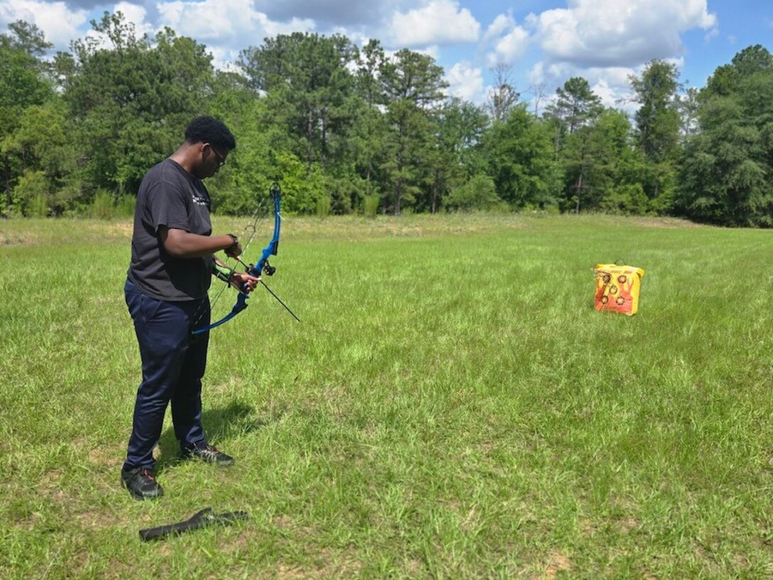 PFC Michael Romulus is about to aim in archery practice at the Fort Moore SRU.