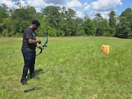 PFC Michael Romulus is about to aim in archery practice at the Fort Moore SRU.