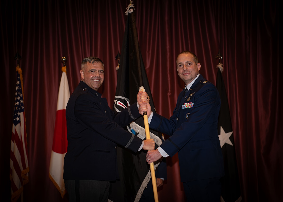Two people holding a flag