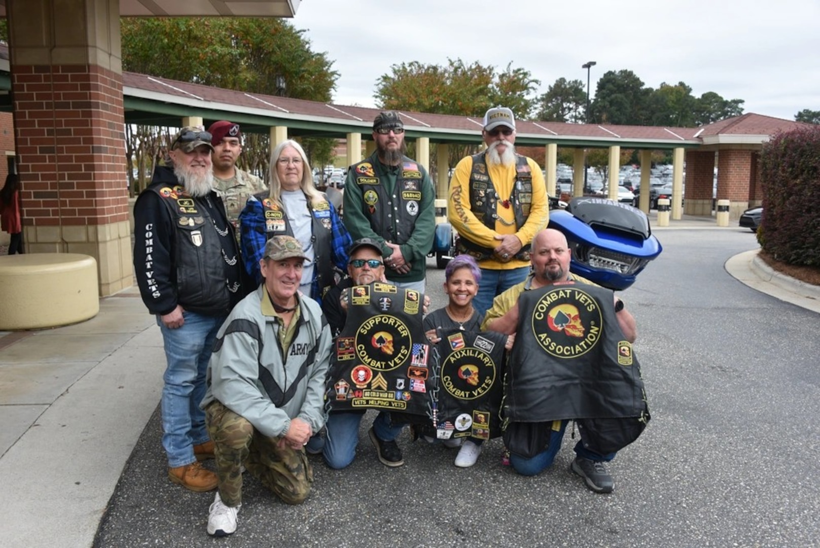 Thomas McBrien, (left front) curator of the 9/11 Memorial Flag poses with the patriotic bikers following the delivery of the flag to Womack Army Medical Center.