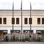 Adm. Stuart Munsch, commander, U.S. Naval Forces Europe-Africa (NAVEUR-NAVAF), and Rear Adm. Patrick Hayden, Director, Maritime Headquarters for NAVEUR-NAVAF, gather with U.S. Navy and Marine Corps attachés, Personnel Exchange Program Officers, and U.S. 6th Fleet liaison officers stationed throughout Europe and Africa at the 2024 U.S. Maritime Security Cooperation and Attaché Symposium in Naples, Italy, Dec. 3, 2024.