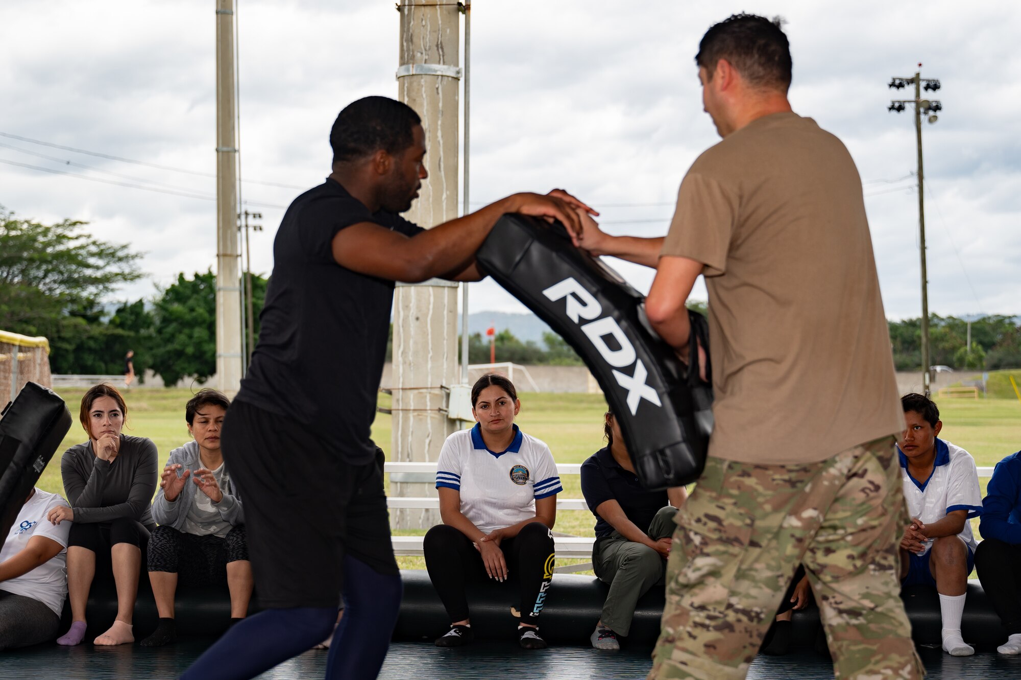 (Left) U.S. Army Sgt. Eric Moshay and (right) Spc. Ty McCarter, Army Forces Command, Joint Task Force-Bravo, teach Honduran Air Force service members combatives during the EmpowerHER combatives class at Soto Cano Air Base, Honduras, Dec. 3, 2024.