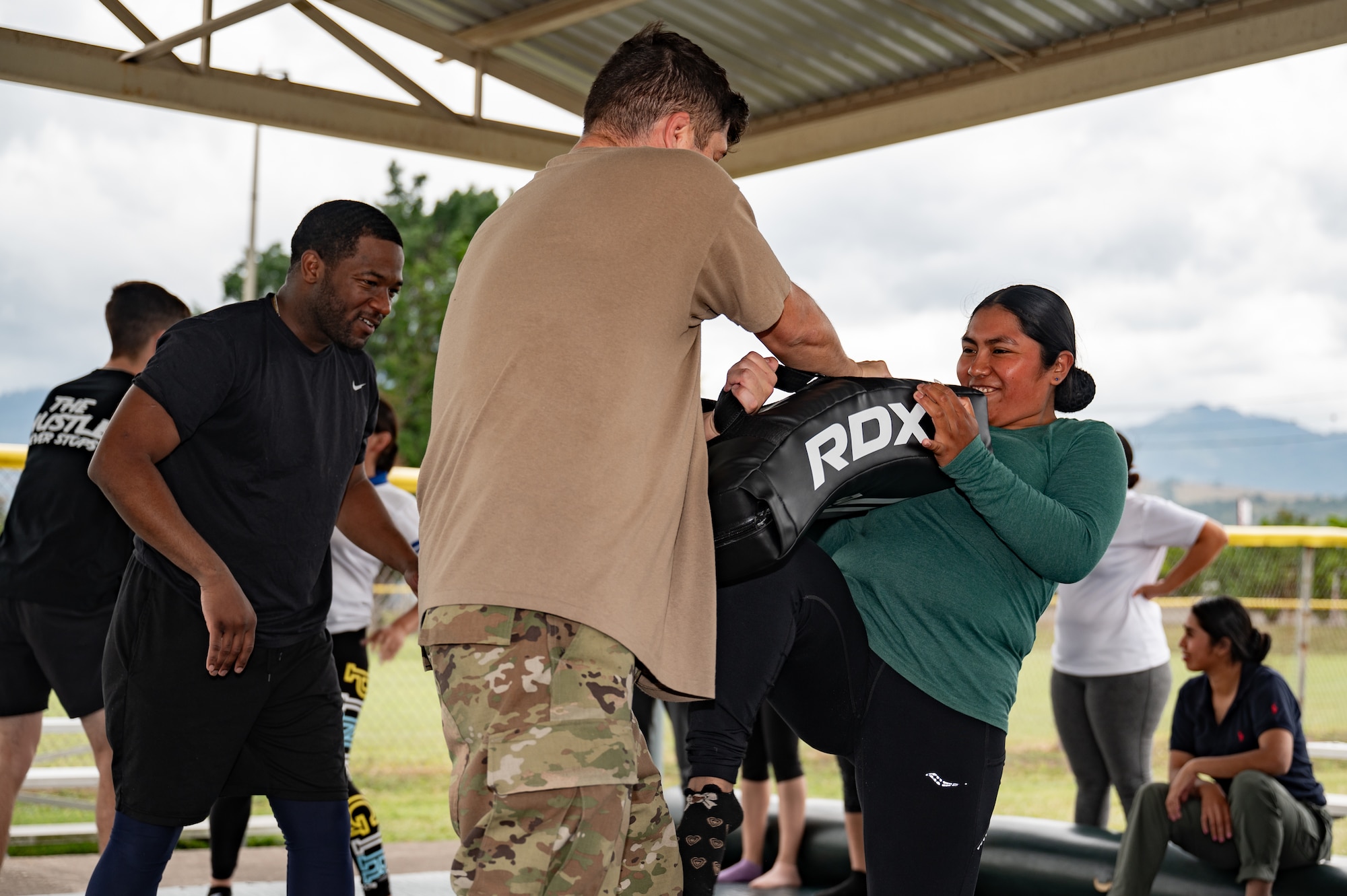 (Left) U.S. Army Sgt. Eric Moshay and (right) Spc. Ty McCarter, Army Forces Command, Joint Task Force-Bravo, teach a Honduran Air Force service member combatives during the EmpowerHER combatives class at Soto Cano Air Base, Honduras, Dec. 3, 2024.