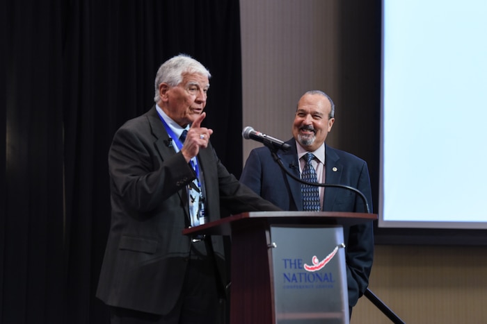Image of two people speaking.