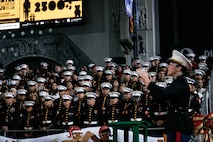 U.S. Marine Corps Officer in Charge of Marine Band San Diego, Warrant Officer Megan Harper, Headquarters and Service Battalion MCRD San Diego, conducts during the 92nd Hollywood Parade in Hollywood, California, Dec. 1, 2024. Marine Band San Diego participated in the parade to improve community relations, increase morale, and demonstrate holiday spirit. (U.S. Marine Corps photo by Cpl. Sarah M. Grawcock)
