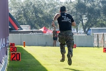 U.S. Marine Corps Sgt. Erynn Hernandez, a recruiter with Recruiting Sub Station Baybrook, Recruiting Station Houston, runs a 40-yard dash  during the Houston Texans vs. Tennessee Titans football game at NRG Stadium in Houston, Texas, Nov. 24, 2024. Marines with RS Houston challenged fans and attendees with a pull-up challenge to win prizes to support the National Football League's Salute To Service game along with the other military branches. (U.S. Marine Corps photo by Sgt. Ryan H. Pulliam)