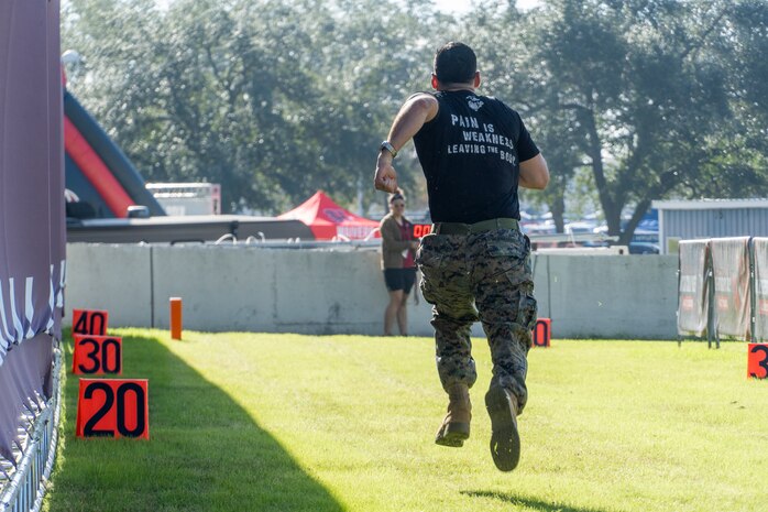 U.S. Marine Corps Sgt. Erynn Hernandez, a recruiter with Recruiting Sub Station Baybrook, Recruiting Station Houston, runs a 40-yard dash  during the Houston Texans vs. Tennessee Titans football game at NRG Stadium in Houston, Texas, Nov. 24, 2024. Marines with RS Houston challenged fans and attendees with a pull-up challenge to win prizes to support the National Football League's Salute To Service game along with the other military branches. (U.S. Marine Corps photo by Sgt. Ryan H. Pulliam)