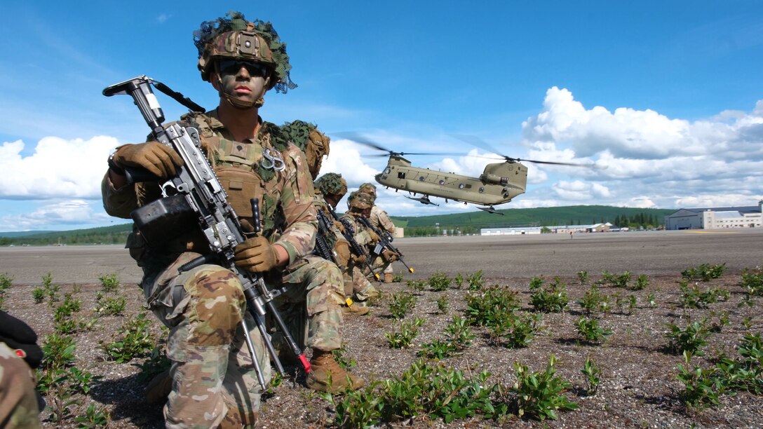 Soldiers assigned to 1st Infantry Brigade Combat Team, 11th Airborne Division, pull security as a CH-47 Chinook lands during a large air assault operation as part of Arctic Angel Rendezvous Week on Fort Wainwright June 4, 2024.