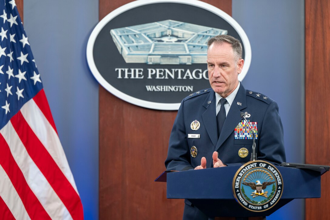 A military official speaks from behind a lectern in front of the Pentagon logo and next to a U.S. flag.
