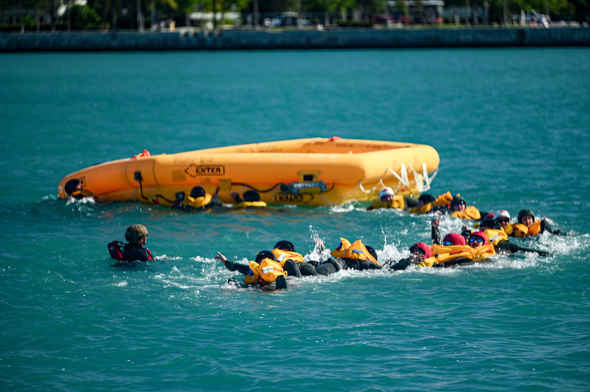 Reservists from the 445th Operation Group’s 89th Airlift Squadron, 445th Aeromedical Evacuation Squadron and 445th Operations Support Squadron make their way to a 46-man life raft during water survival training alongside the U.S. Naval Air Station Key West Search and Rescue, Sector Key West Coast Guard and Key West Police Department in Key West, Florida Nov. 22, 2024. Over 80 reservists from Ops, 445th Maintenance Group, 445th Mission Support Group and 445th Airlift Wing medical squadrons participated in or provided support for the joint training event Nov. 21-22, 2024. Training included water survival and urban survival, evasion, resistance and escape. AES Airmen also conducted training flights to fulfill their training requirements. (U.S. Air Force photo/Master Sgt. Patrick O’Reilly)