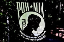 The POW/MIA Flag raised during a DPAA Recovery Mission. Designed by World War II veteran Newt Heisley and initially adopted by family members of the Vietnam missing and unaccounted for, it has now become the organizational emblem of the DPAA to represent its mission.