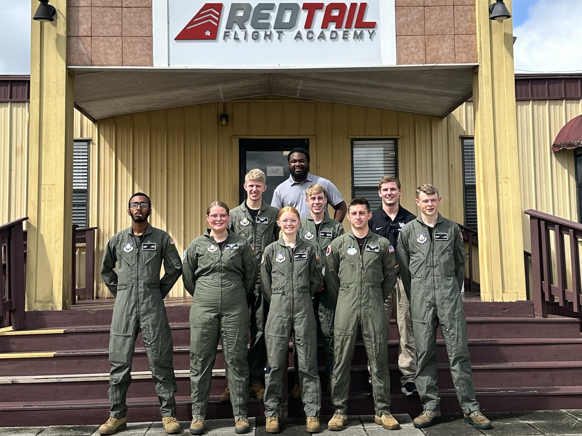 Cadets and instructors pose for a photo prior to their graduation from the Air Force Junior ROTC Flight Academy at Moton Field Municipal Airport