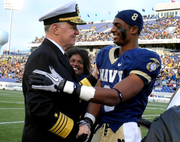 Chief of Naval Operations Adm. Gary Roughead congratulates Navy safety Wyatt Middleton and the rest of the senior class players prior to the Naval Academy football game against Arkansas State at the Navy/Marine Corps Memorial Stadium in Annapolis. The Midshipmen beat the Red Wolves, 35-19.