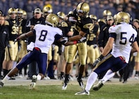 (From left) Safety Wyatt Middleton, Slot Back Malcolm Brown and Linebacker Tyler Simmons execute a play during 111th Army Navy game  at Lincoln Financial Field in Philadelphia on Dec. 11.