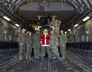 U.S. service members pose for a group photo after offloading toys on Marine Corps Air Station New River, in Jacksonville, North Carolina, Dec. 3, 2024.