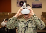 A Sailor from MARMC tests the Oculus headset utilized for sexual assault prevention and suicide prevention virtual reality training at Naval Station Norfolk.