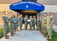 Logistics Specialist Seaman (LSSN) Christelle V. Abrego, a San Antonio, Texas, native and graduate of Madison High School, receives a certificate of recognition from the Naval Medical Forces Pacific’s Command Master Chief Jerry Cantorna for capturing the Blue Jacket of the Year award for Navy Medicine Readiness and Training Command (NMRTC) San Diego, Nov. 7, 2024. Currently serving with NMFP’s Unit Deployment Cell (UDC), Abrego plays a pivotal role as an operations action officer and primary medical supply purchaser for the NMFP region. (Navy photo by Arsenio R. Cortez Jr.)