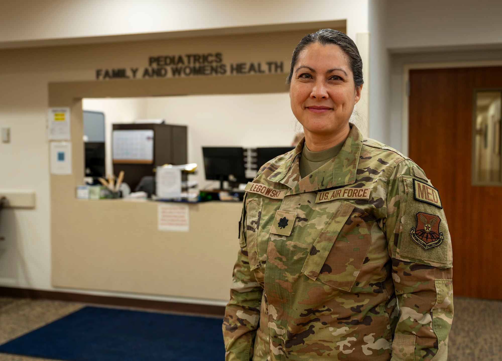 A woman in uniform posing for a photo.