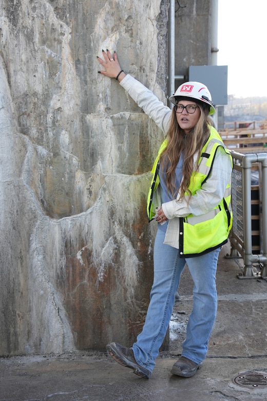 Cayce Grall, project manager-forward for the U.S. Army Corps of Engineers Nashville District’s Chickamauga Lock Replacement project in Chattanooga, Tennessee, points out alkali-aggregate reaction, a chemical process that causes concrete to expand and crack, threatening the structural integrity of Chickamauga Lock and Dam during a tour for students from the Concrete Fundamentals Prospect Course offered by the Huntsville Learning Center on Dec. 3, 2024.