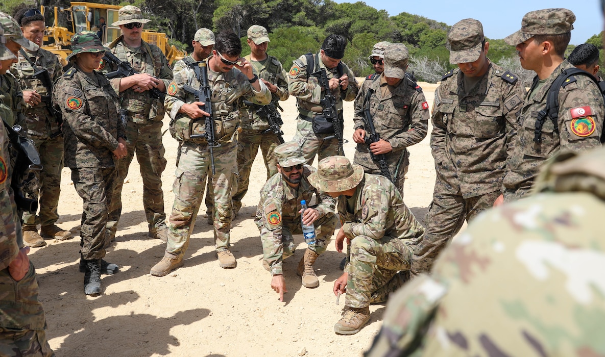 U.S. Air Force Tech. Sgt. Becker Almarsumi, a linguist with the 439th Supply Chain Operations Squadron, translates the exercise plan to U.S. Army Soldiers from 1st Battalion, 175th Infantry Regiment, Maryland National Guard, at African Lion 2024 (AL24) in Bizerte, Tunisia, May 7, 2024. AL24 marks the 20th anniversary of U.S. Africa Command’s premiere joint exercise led by U.S. Army Southern European Task Force, Africa (SETAF-AF), running from April 19 to May 31 across Morocco, Ghana, Senegal and Tunisia, with over 8,100 participants from 27 nations and NATO contingents. (U.S. Army Photo by Spc. Shawn Fogleman)