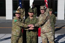From left to right: Maj. Gen. Ash Collingburn, 1st Australian Division commanding general, Lt. Gen. Toshikazu Yamane, Ground Component Command commanding general, and U.S. Army Lt. Gen. Joel B. Vowell, U.S. Army Pacific Command deputy commanding general, shake hands during the opening ceremony of Yama Sakura 87.